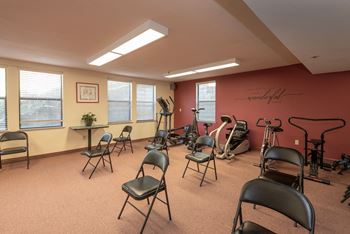 Fitness center with exercise equipment and folding chairs